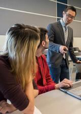 An instructor discusses a topic with students