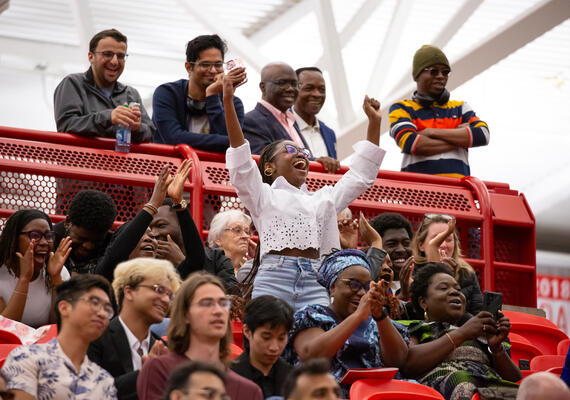 A family cheers on their graduate
